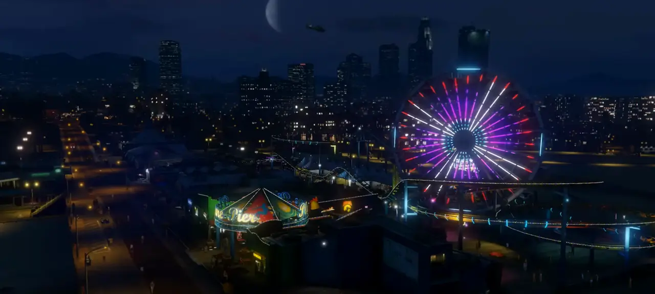 Del Perro Pier's lit-up Ferris wheel at night with the downtown skyline behind