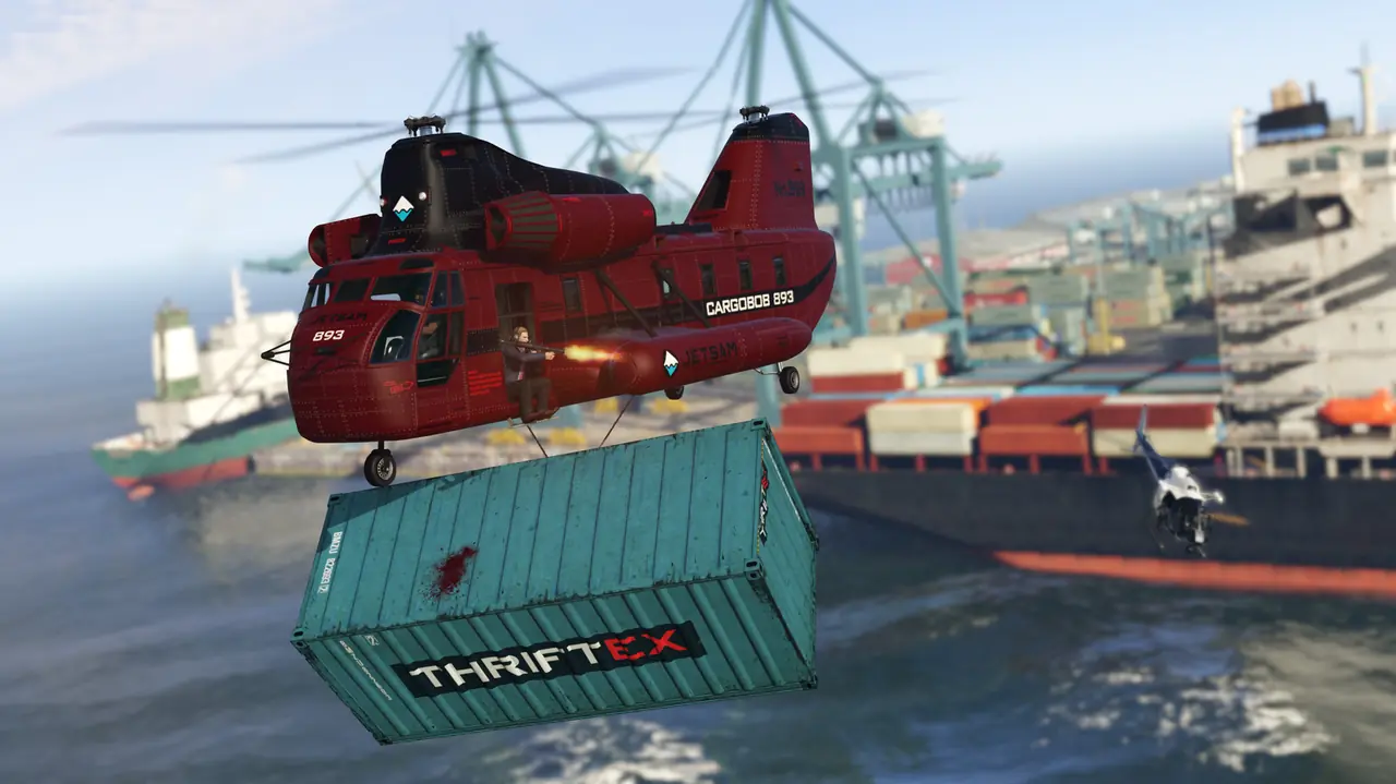 Red Cargobob lifting a shipping container over the docks