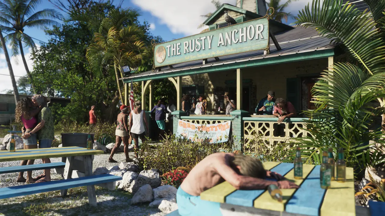 The Rusty Anchor, a waterfront bar in the Keys, with drinkers on the deck and a man passed out on a picnic table