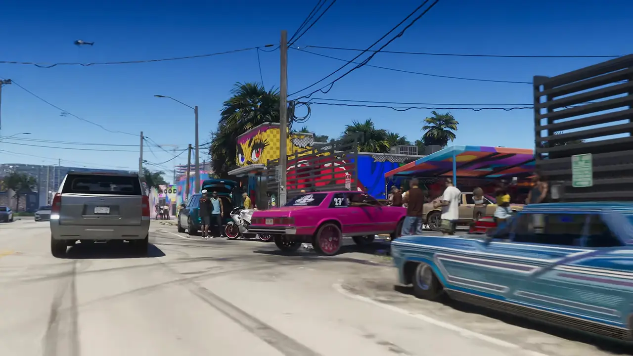 Lowriders, including a pink one on gold wheels and a light-blue one, lined up on a street of colourful murals