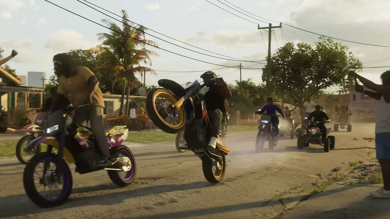 Riders popping wheelies on dirt bikes and quads down a dusty residential street
