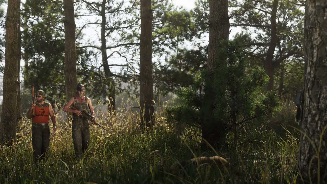 Two hunters with rifles walking through tall grass in a pine forest in Mount Kalaga National Park